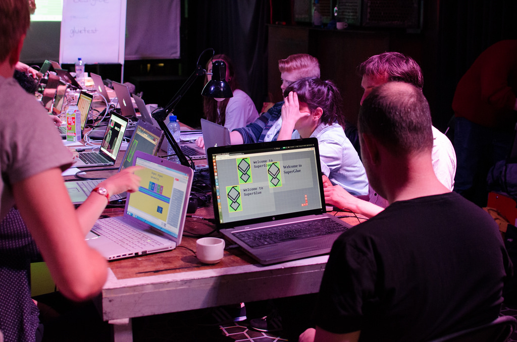 Superglue workshop: participants working on laptops with the Superglue welcome screen on display.